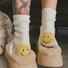 White smiley knitted socks made of soft cotton blend yarn, cozy for daily wear.