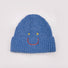 Front view of Smiley Ribbed Knit Beanie in blue. Playful winter staple crafted for daily warmth and style.
