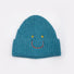 Front view of Smiley Ribbed Knit Beanie in peacock blue. Durable knit frame with an artistic smiley detail.
