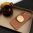 Brown silicone case with gold kickstand on a gold tray, reflecting a premium luxury lifestyle.