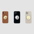 Three silicone iPhone cases in brown, black, and beige with integrated gold or silver metallic kickstands.