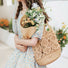 Model carrying a camel Spiral Pattern Hollow Crochet Bag on shoulder, easy for commuting and weekends.