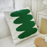 Side view of White cotton Spring Vibe pillow cover with a vibrant green abstract tufted design.