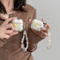Model Hands holding two Starry Dream Airpods Case Covers with different sizes.