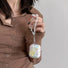 Moldel grabing the strap of Starry Dream Airpods Case Cover, ideal for gifting and everyday use.