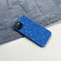 Blue Starry Night case with yellow stars and swirling lines, resting on a denim background.