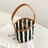 Folded view of Stripe Woven Bucket Bag, easy for commuting and weekends.