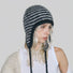 Side view of model wearing the classic black and white striped earflap hat.