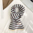 Flat lay of Striped Knitted Scarf in white and brown, great for office layering and commuting.