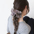 Model wearing a Striped Layered Scrunchie in brown, ideal for quick updos and ponytails.