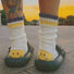 White striped knit socks with a signature smiley heel for a playful, unique look.