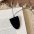 Folded view of Suede Arrow Eyeglass Holder Necklace in Black, easy to style.