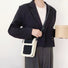 Model carrying a black Suede Crossbody Bag With Plush Trim as crossbody , easy for commuting and weekends.