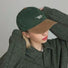 Model wearing green Sun Day Cap. Crafted from premium cotton for all-day breathability and outdoor comfort.