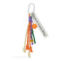 Front view of Polyester tassel bag charm with white carabiner, Have a nice day tag, orange dice, and smiley face.