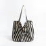 Black and white thin stripe canvas tote bag with shoulder strap and open top.