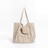 Front view of khaki and white striped canvas tote, minimalist aesthetic ideal for summer vacations.