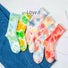 Front view of Six pairs of colorful tie-dye crew socks.