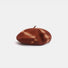 Brick red and beige tie-dye wool beret displayed on a white background.