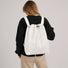 Model wearing the off-white ultralight 2-way drawstring backpack on her back.