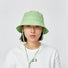 Model wearing green Ultralight Quick Dry Bucket Hat, designed for peak performance and sun protection outdoors.