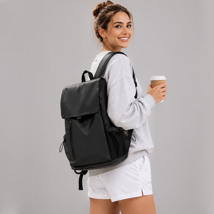Model carrying the black urban waterproof flap backpack with coffee cup.