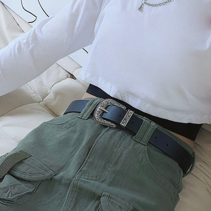 Black PU leather belt with an ornate vintage silver buckle, worn with green cargo pants.