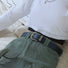 Black PU leather belt with an ornate vintage silver buckle, worn with green cargo pants.