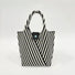 Angled view of Vintage striped knitted handbag in black.