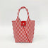 Close-up of Vintage striped knitted polyester handbag with red and white chevron pattern, red strap, and magnetic.
