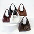 Five waxed leather hobo bags in different colors on a white background