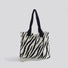 Folded view of Zebra Print Knitted Tote Bag in black and white, easy for commuting and weekends.