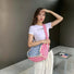 Model carrying a blue striped tote bag on the shoulder , ideal for city walks and gifting.