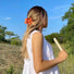 Model wearing a Candy Flower Hair Claw  in orange, easy for workdays and special occasions.