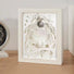 Front view of White carved paper lamp with intricate layered forest and moon design.