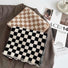 Two wool-blend checkerboard scarves, one black and white, one beige and white, on a brown jacket.
