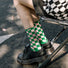 Model wearing a pair of green plaid cotton socks, ideal for everyday outfits and sneakers.