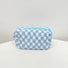 Sky blue checkerboard knit pouch on a white background; minimalist and trendy knit organizer.