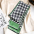 Model wearing a Green and white checkerboard satin skinny scarf on a light top, great for office.