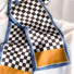 Angled view of Checkerboard Satin Skinny Scarf, great for office layering and commuting.