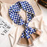 Model wearing a plaid satin scarf in navy and brown and blue, ideal for daily wear and travel.