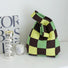 Close-up of  Green and brown checkered tote bag, ideal for errands.
