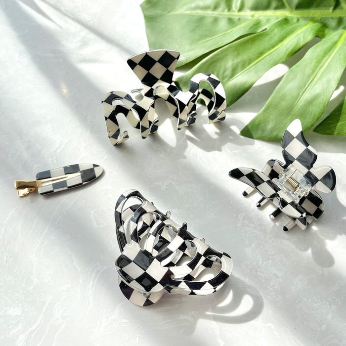 Angled view of  four checkered hair claws in various shopes , ideal for quick updos and ponytails.