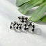 Close-up of checkered hair claw in mcross shape, easy for workdays and special occasions.