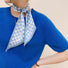 Model wearing a plaid silk scarf in blue, easy for weekend styling and gifting.