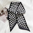 Flat lay of Checkered Silk Like Skinny Scarf in black, great for office layering and commuting.