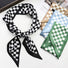 Front view of Black and white checkered silk-like skinny scarf with other color options: blue, green, and tan.