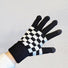 Flat lay checkerboard knitted touch screen gloves, black and cream squares; cozy for winter phone use.