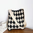 Minimalist black and beige argyle knitted tote bag featuring an open-top design.