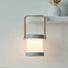 White and wood creative lantern lamp, stretched with glowing LED light, hanging from a shelf.